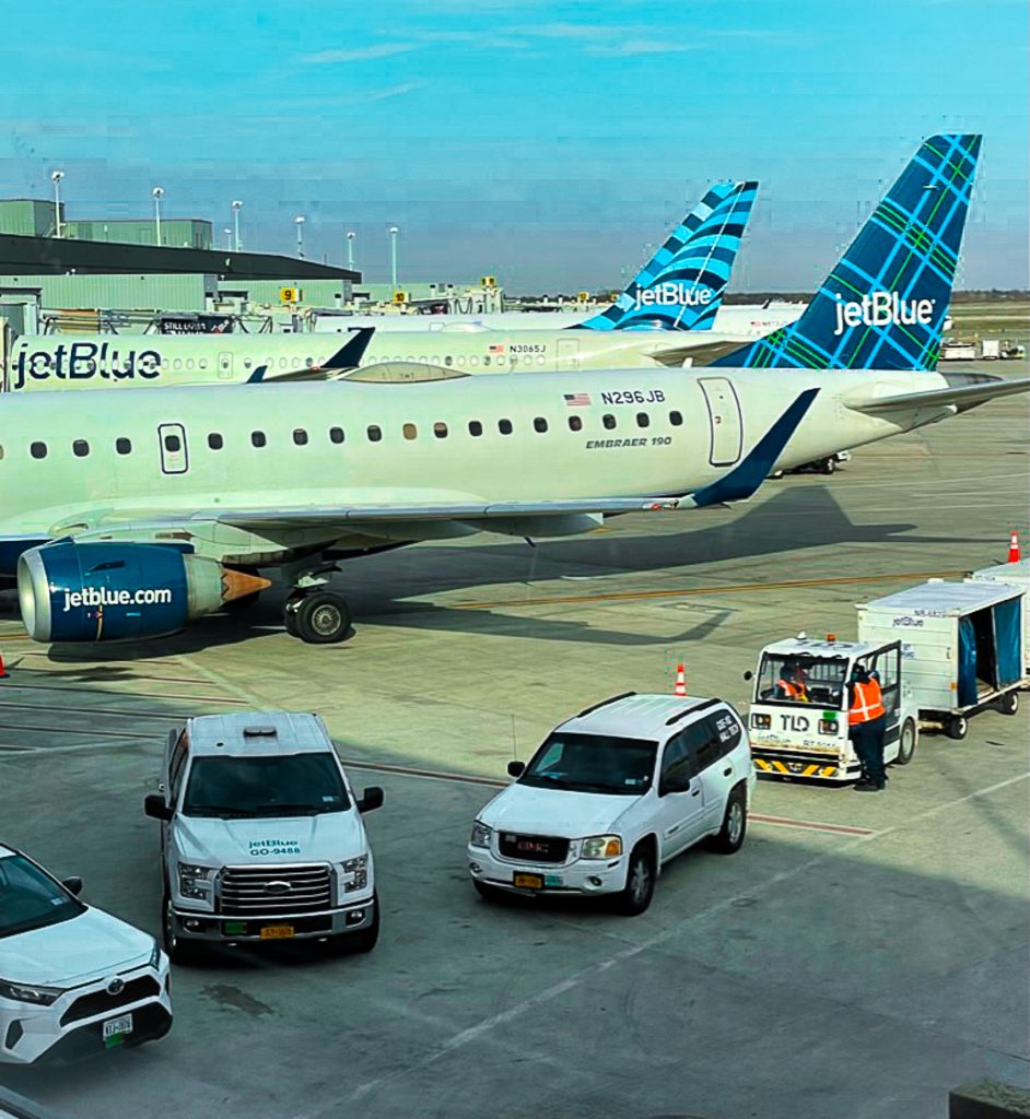 a group of white vehicles parked on a tarmac