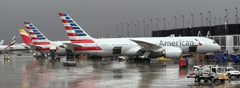 an airplane parked on a wet runway