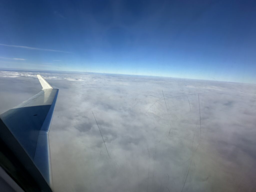 an airplane wing above the clouds