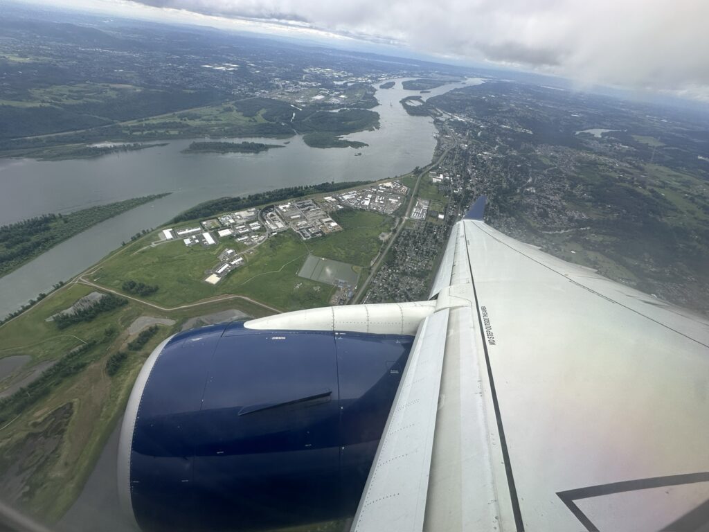 an airplane wing and a body of water