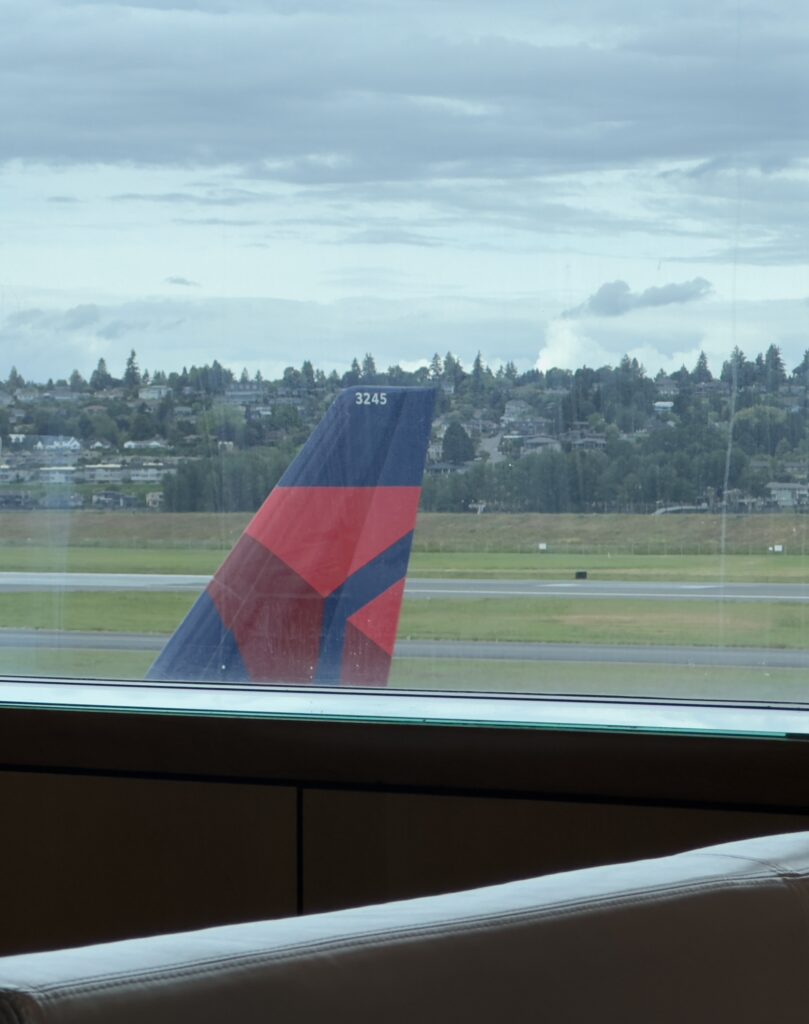 a tail fin of an airplane on a runway