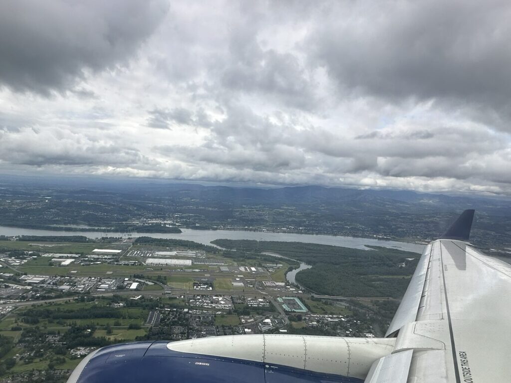 an airplane wing and a body of water