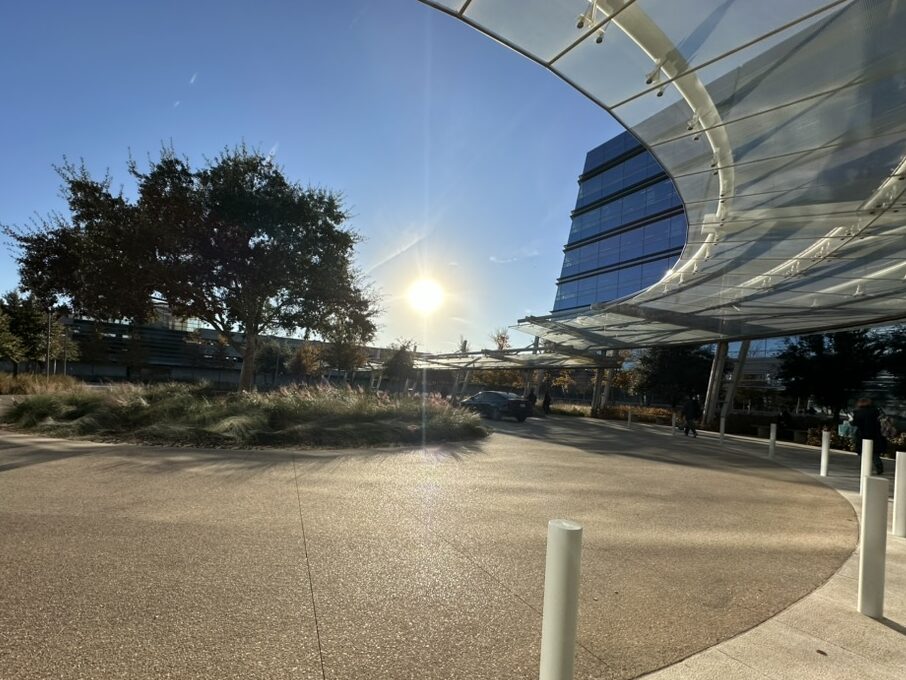 a sun shining through a glass roof