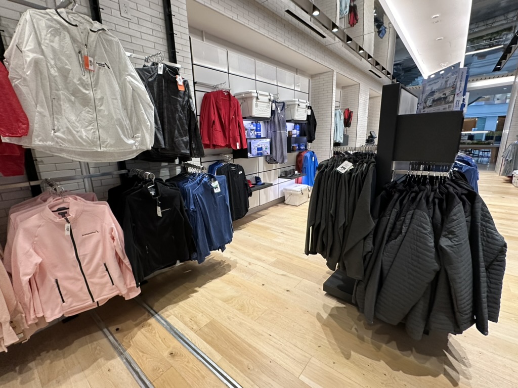 a store with clothes on swingers