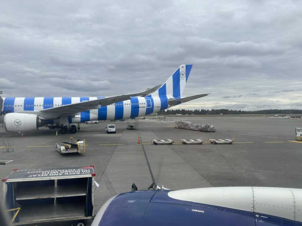 a blue and white airplane on a runway