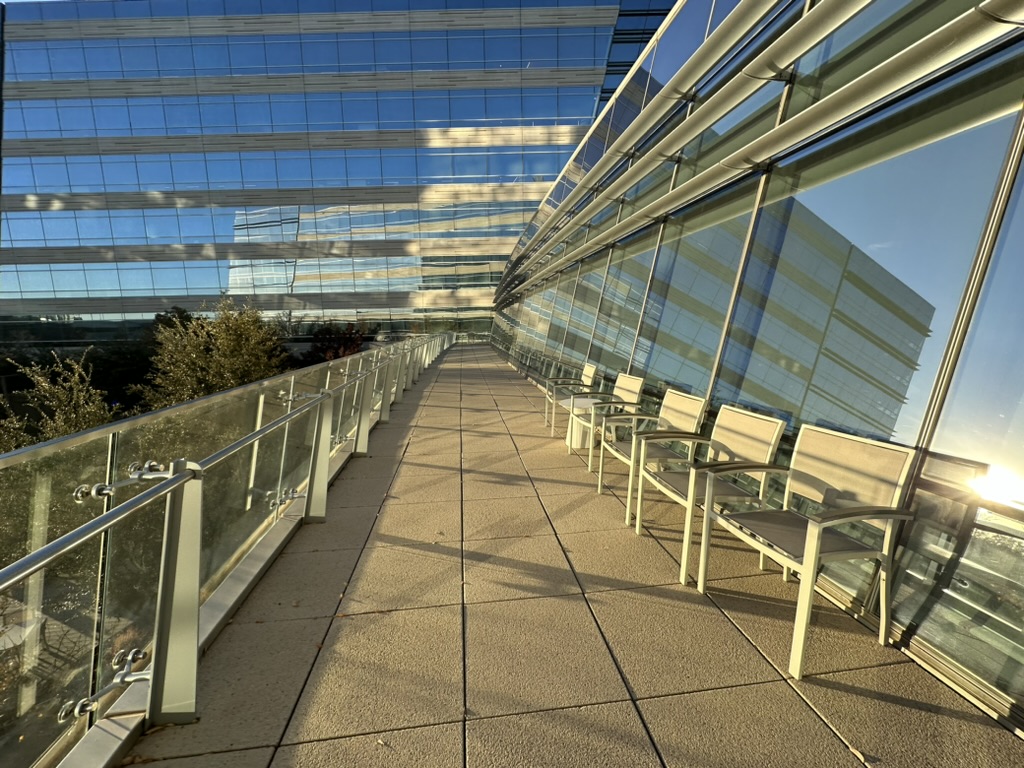 a glass wall with chairs and a glass wall