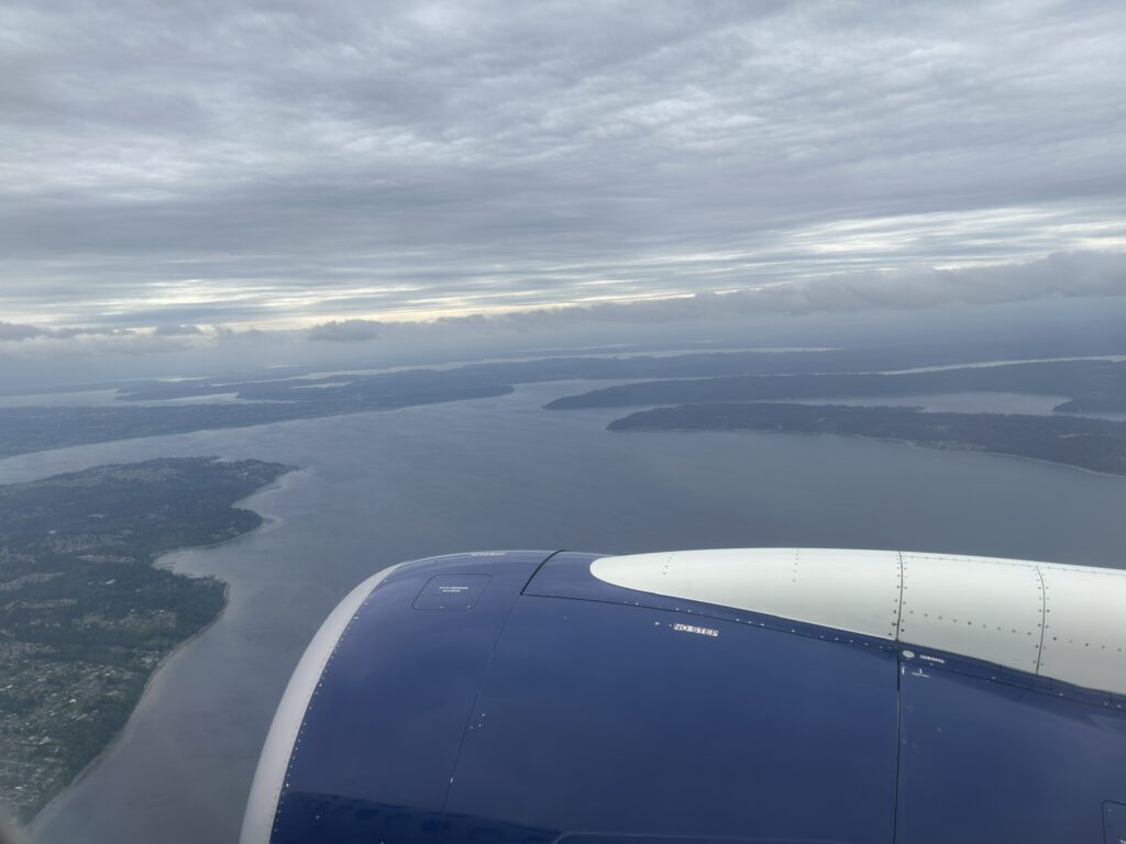 an airplane wing and body of water