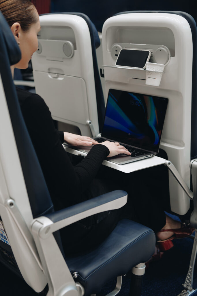 a woman sitting in a chair using a laptop