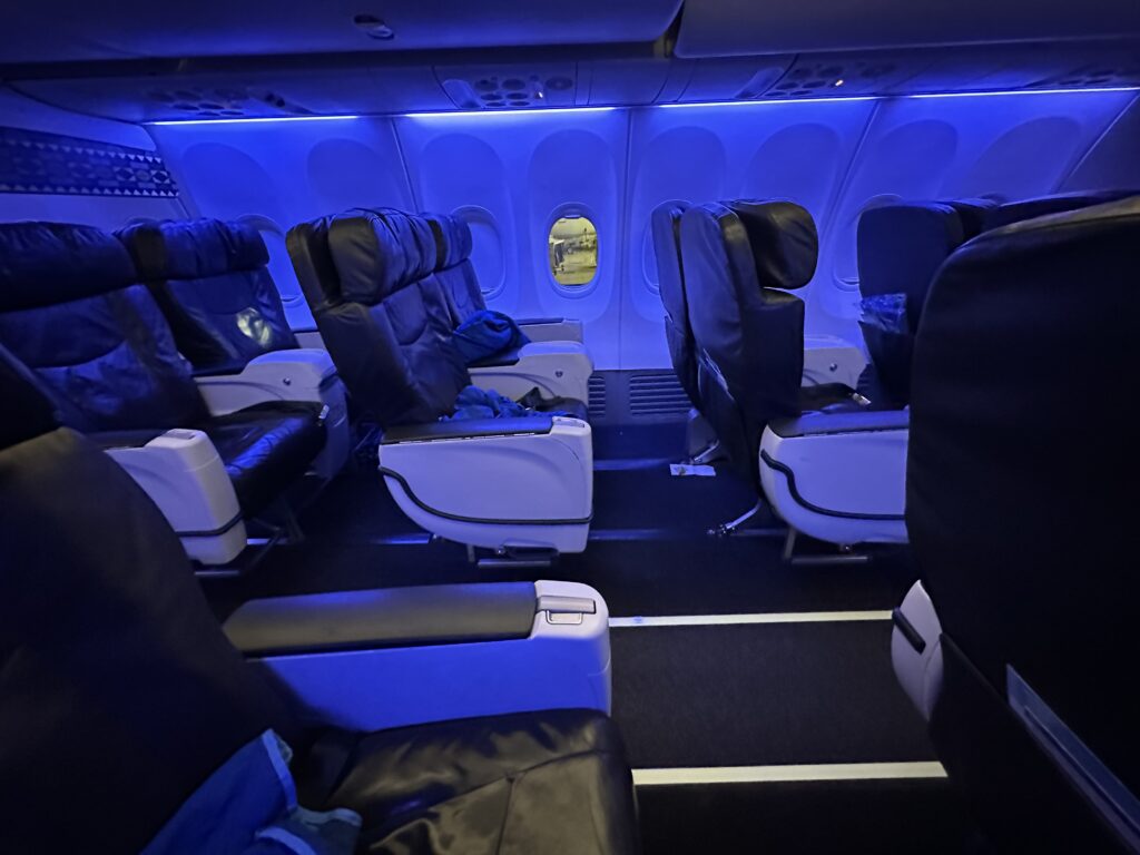 the inside of an airplane with blue lights