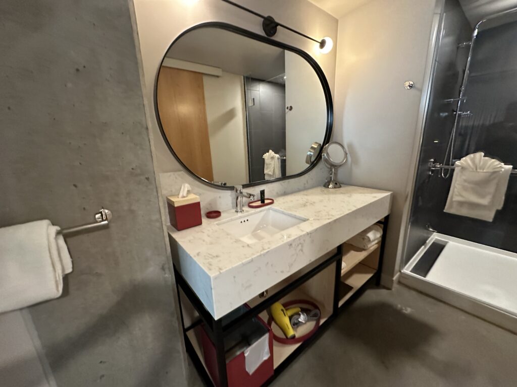 a bathroom with a round mirror