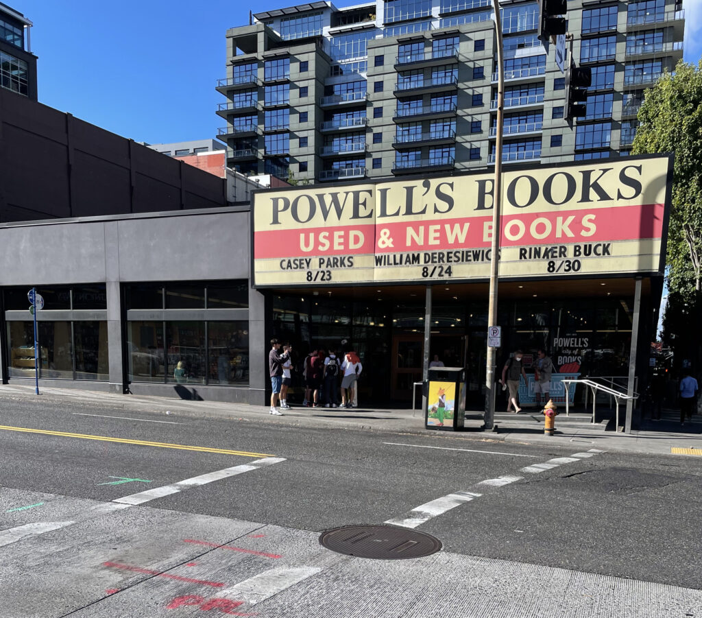 a group of people standing outside of a store