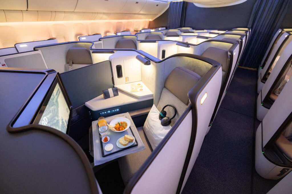 a tray of food on a table in an airplane