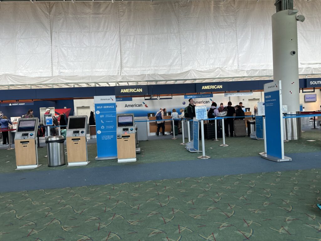 people standing in a line at an airport