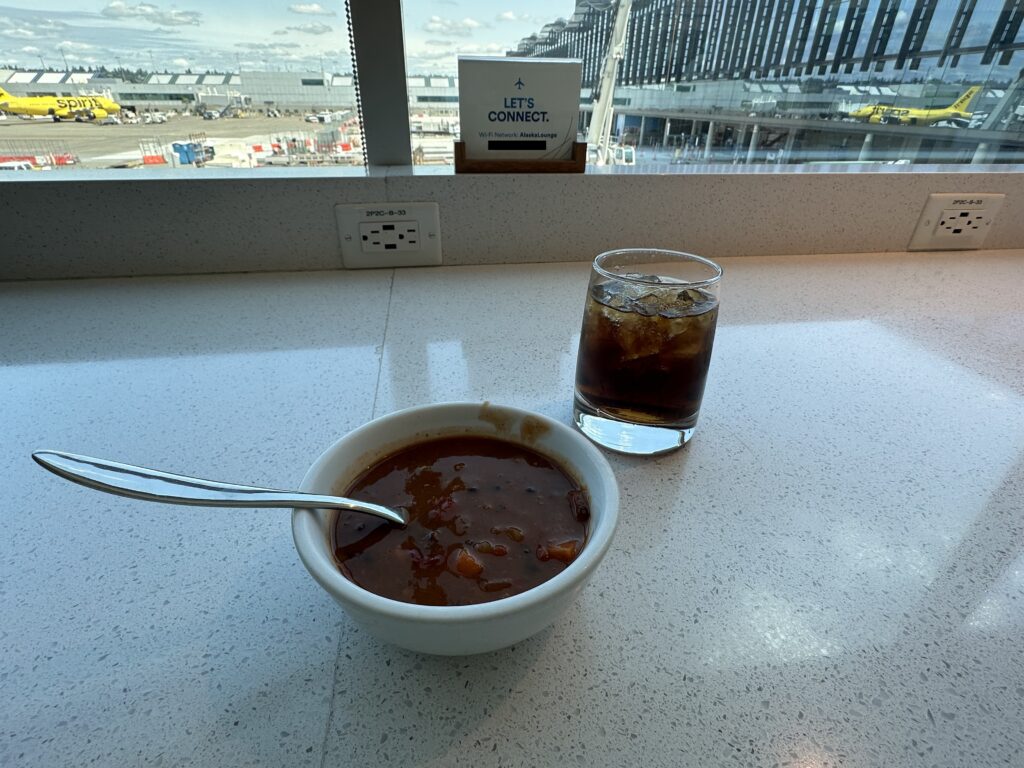 a bowl of soup and a glass of ice on a counter