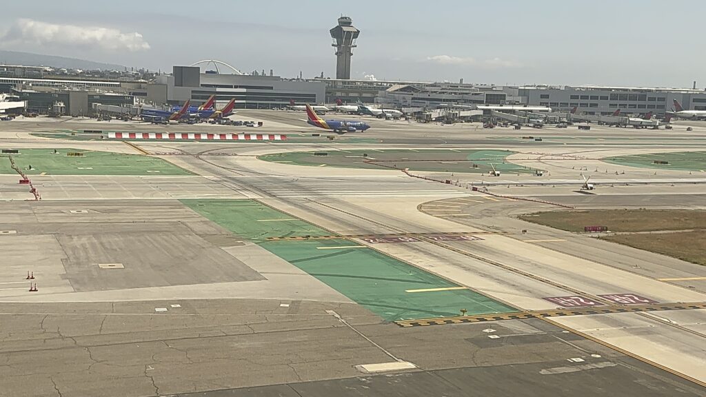 an airport with airplanes on the runway