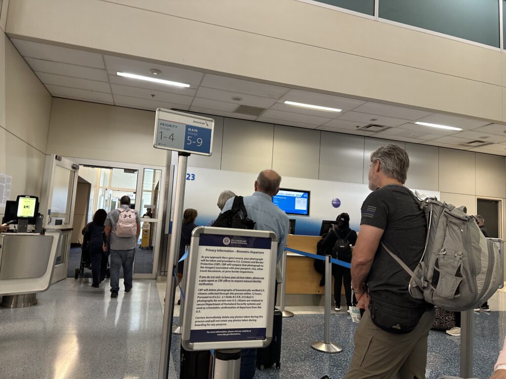 people in a building with people standing in front of a computer