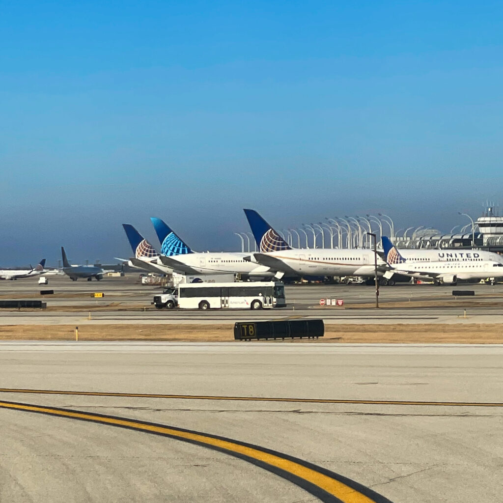 a group of airplanes on a runway