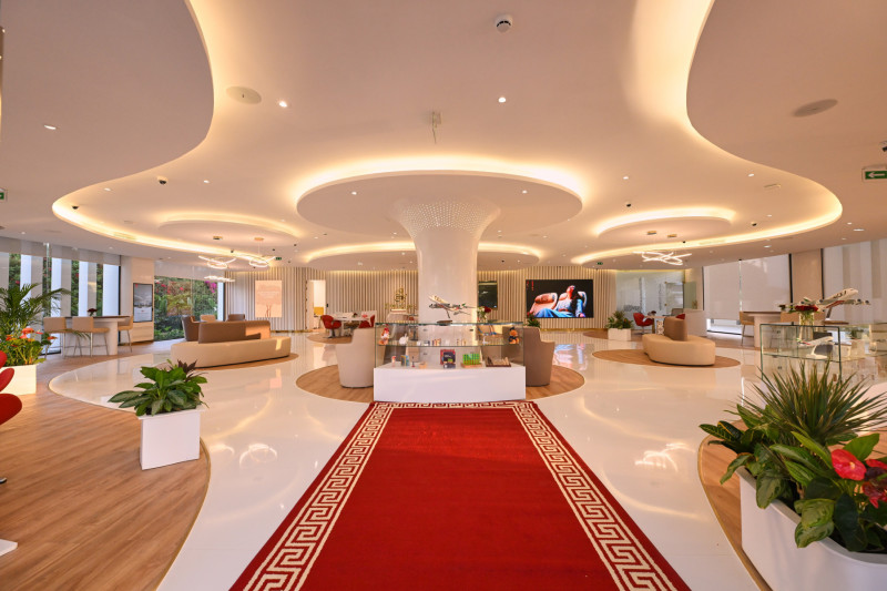 a large room with a red carpet and white walls