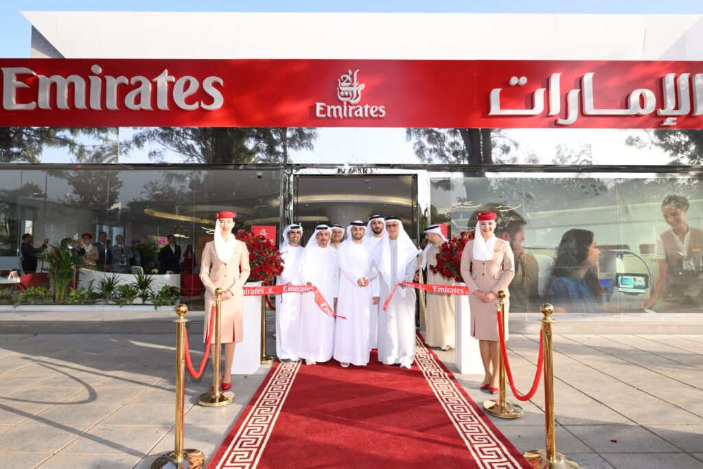 a group of people standing in front of a red carpet