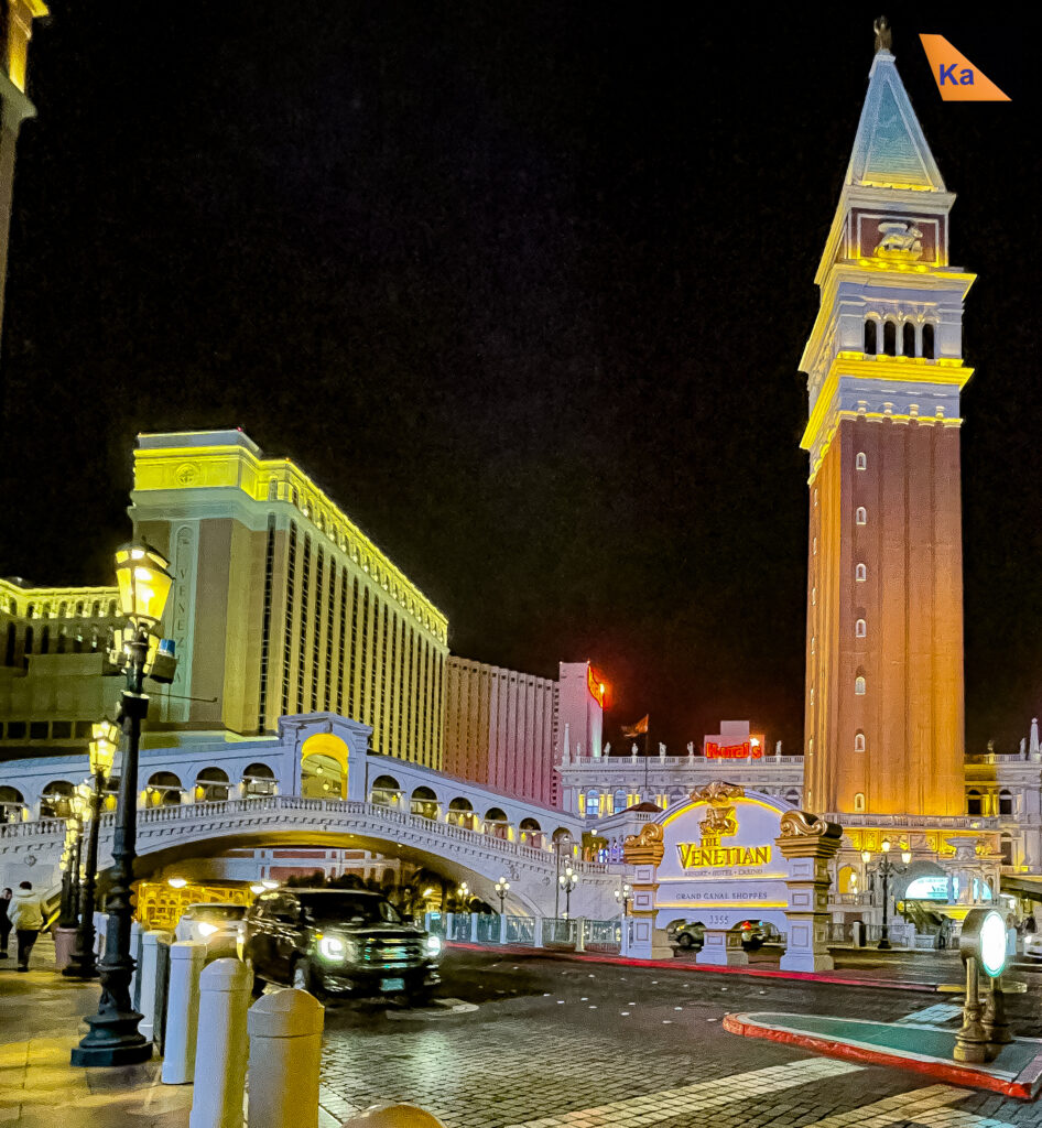 a city street with a clock tower and a bridge