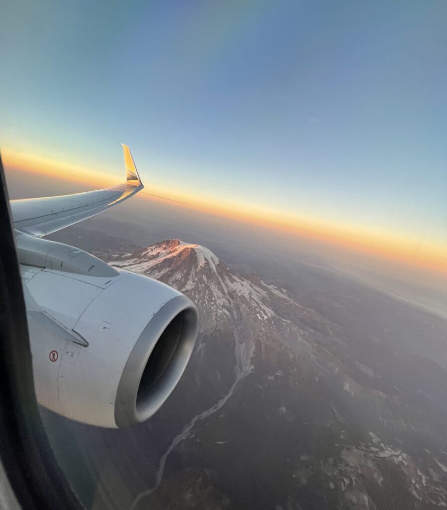 an airplane wing and a mountain