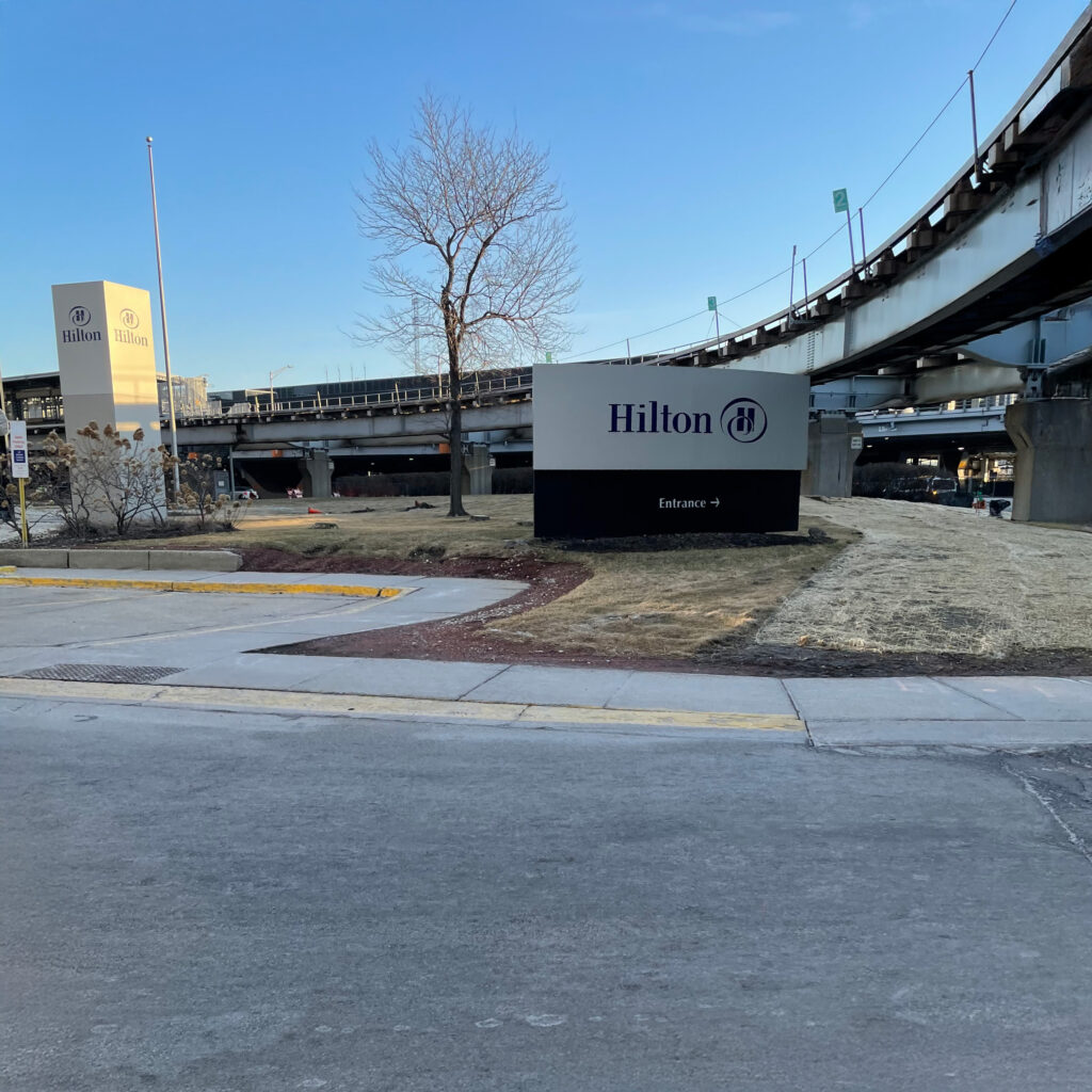 Hilton’s Loyalty Program Evolves With a New Premium Tier 1 a sign next to a road